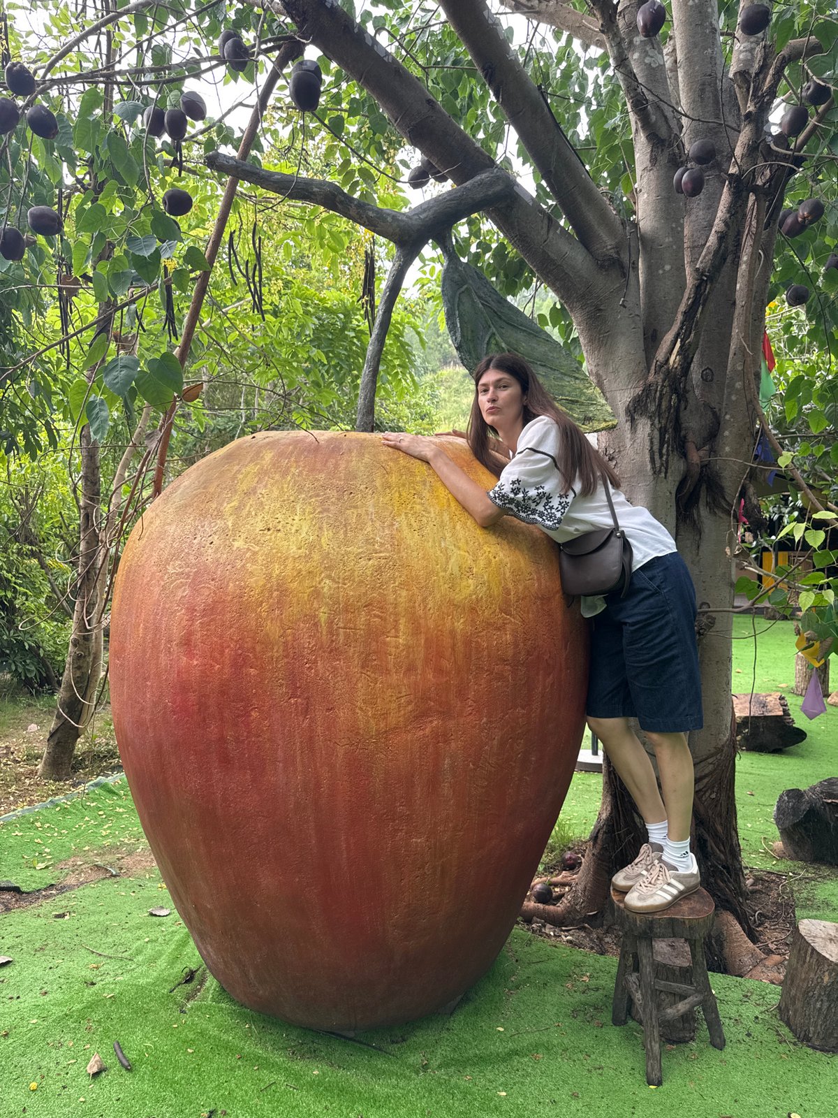 Posing with a giant apple sculpture in Nha Trang
