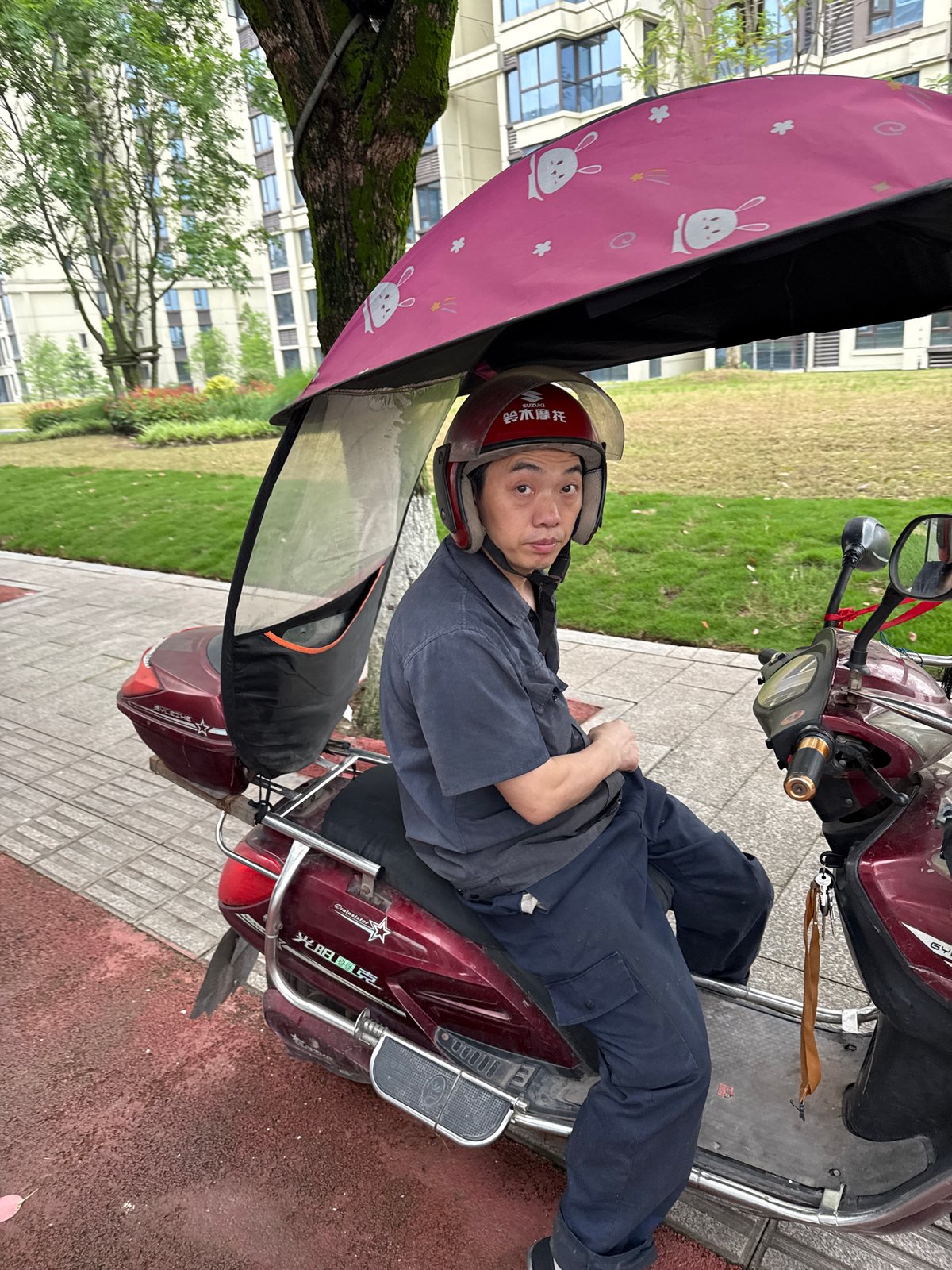 Electric scooter riders navigate streets in Shuangfu, China