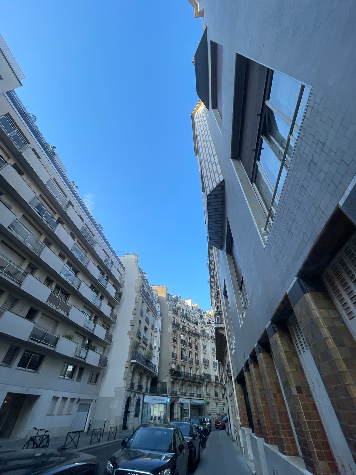 Street and rooftop views across a Parisian neighborhood, August 2026