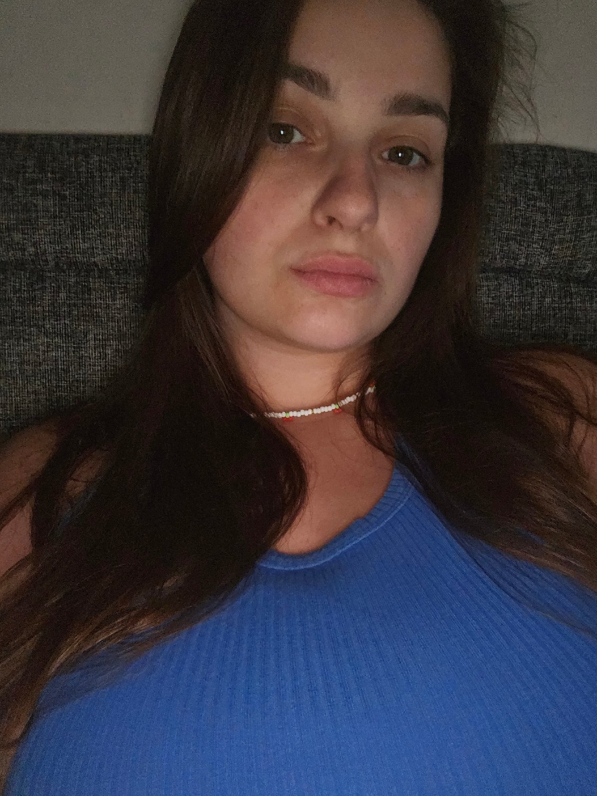 Indoor self-portrait session, blue top and cherry necklace, near Kyiv