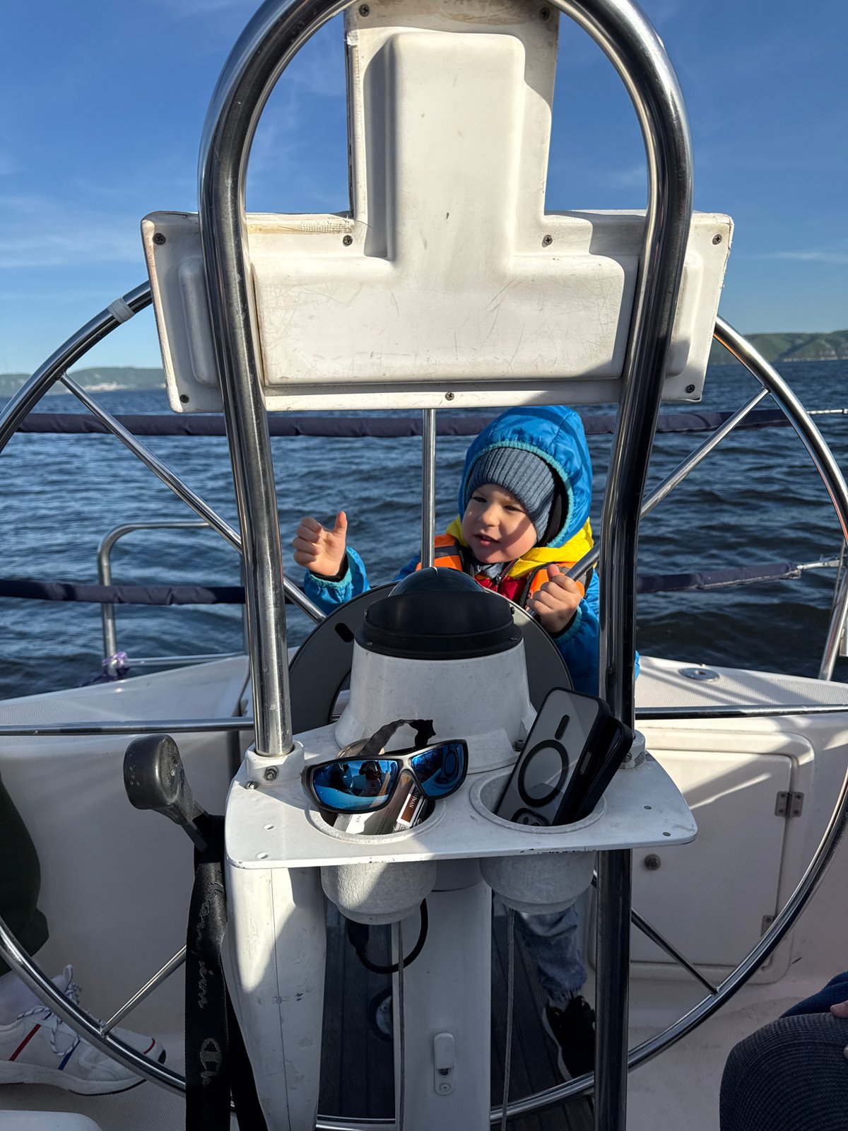 Child takes helm during boat trip near Tolyatti cliffs