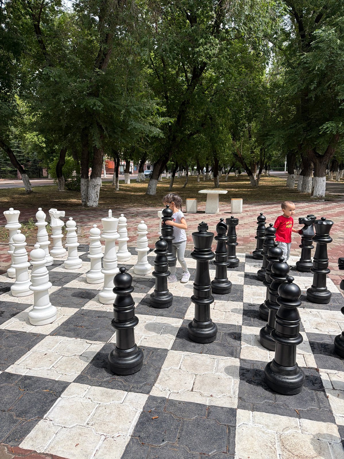 Giant outdoor chess set in a Karaganda park, July morning