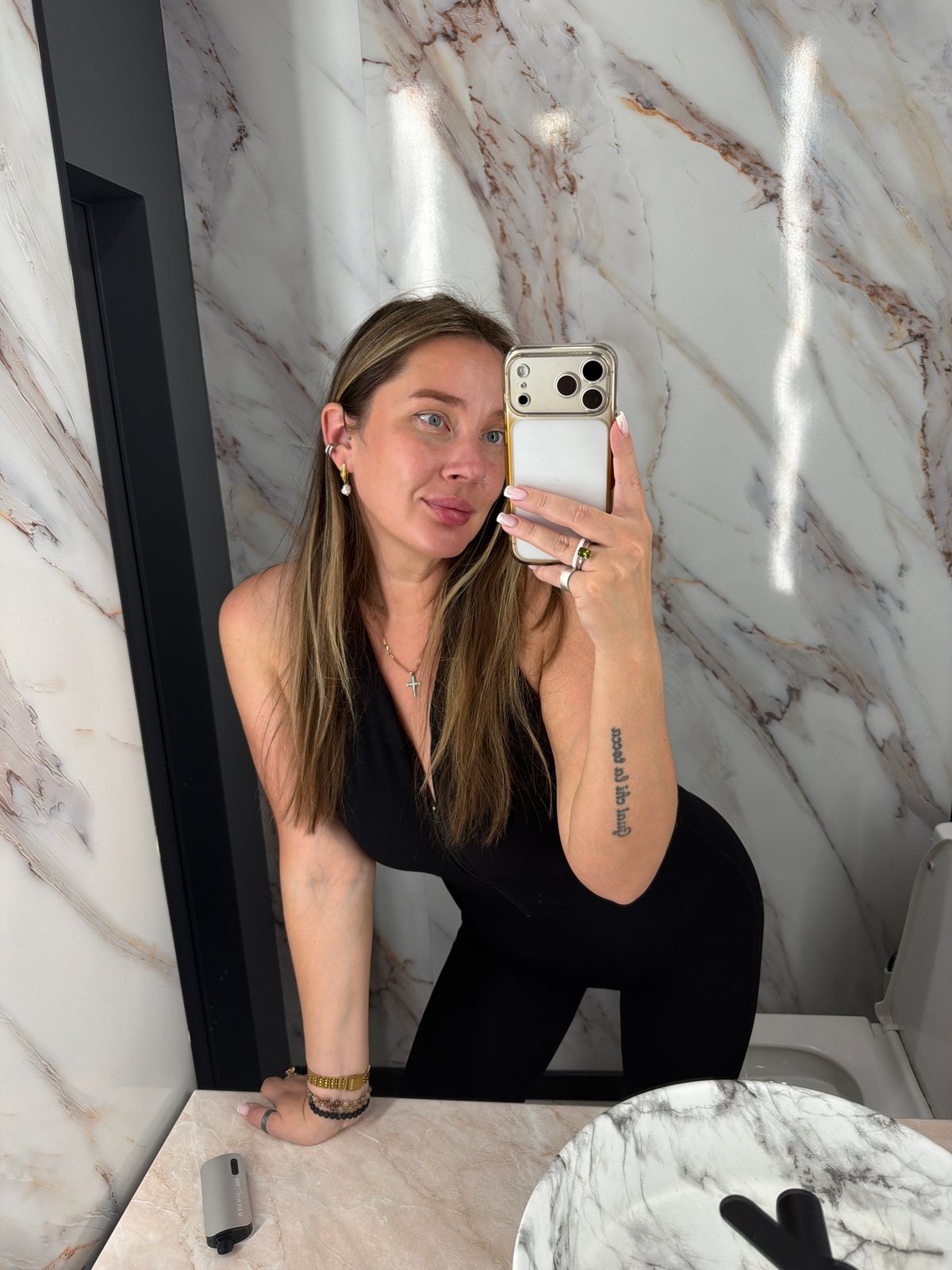 Woman takes bathroom selfie in marble-walled Moscow restroom
