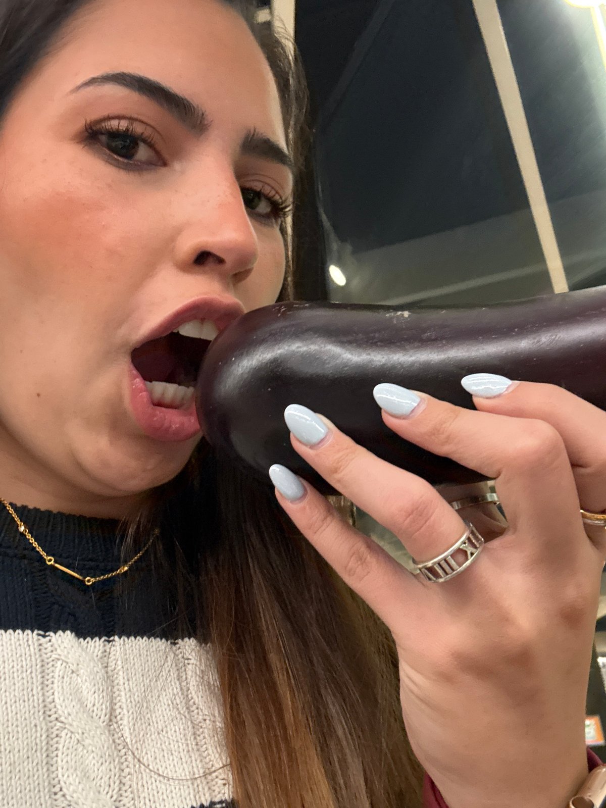 Woman playfully poses with produce during supermarket shopping in Puebla