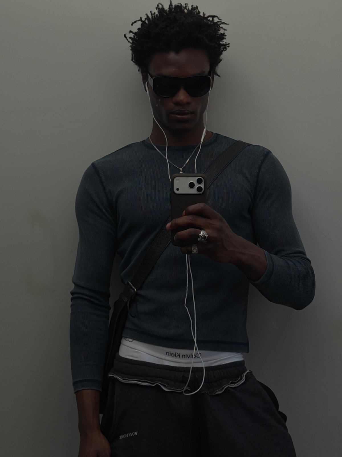 Man takes selfie in London wearing sunglasses and headphones