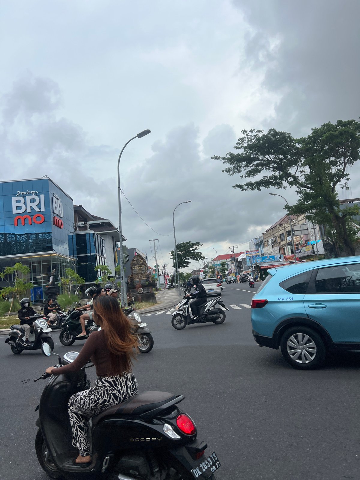 Heavy motorcycle traffic fills Kuta street during morning rush