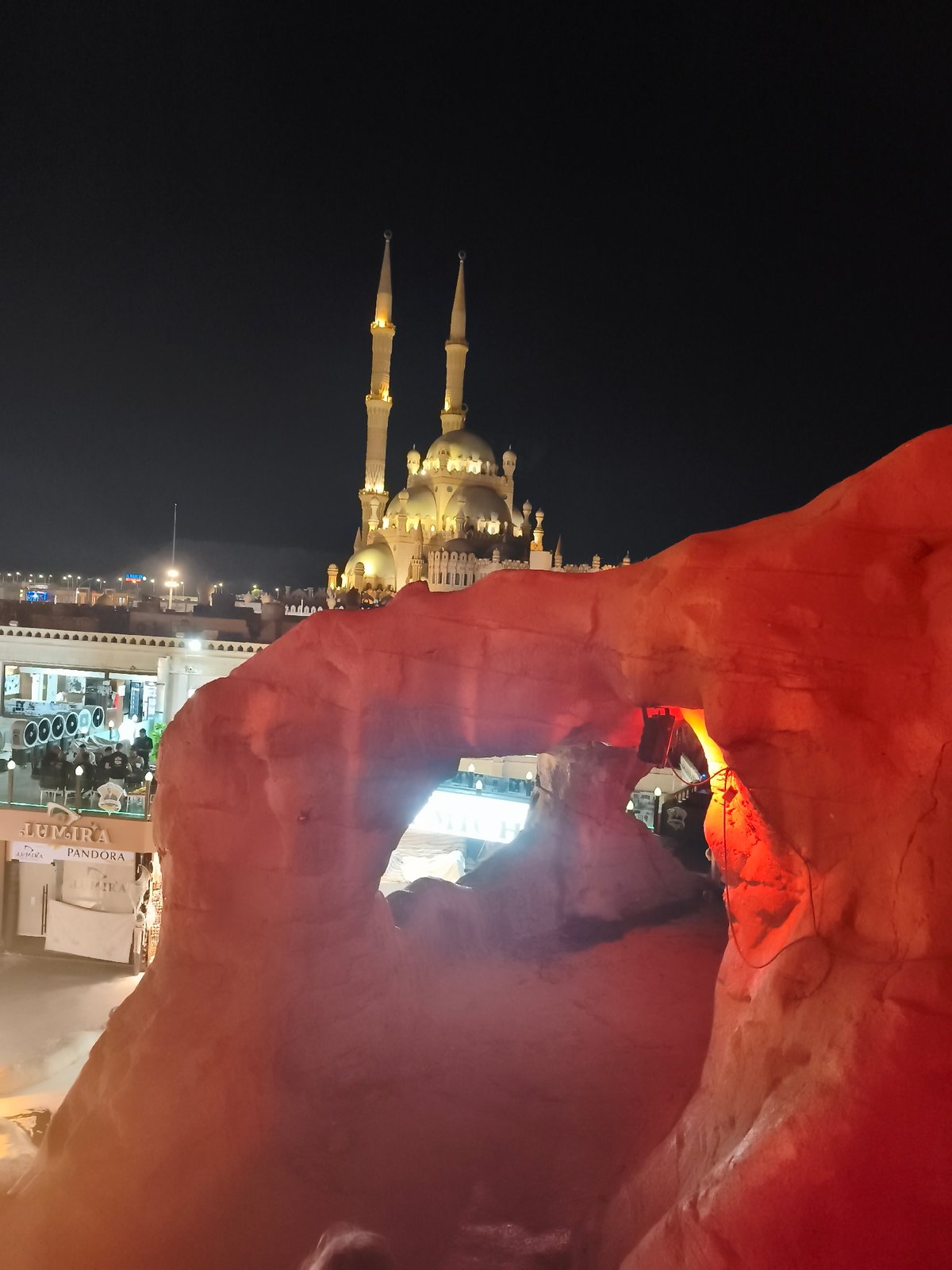 Naama Bay at night: mosque, markets, and cave venues