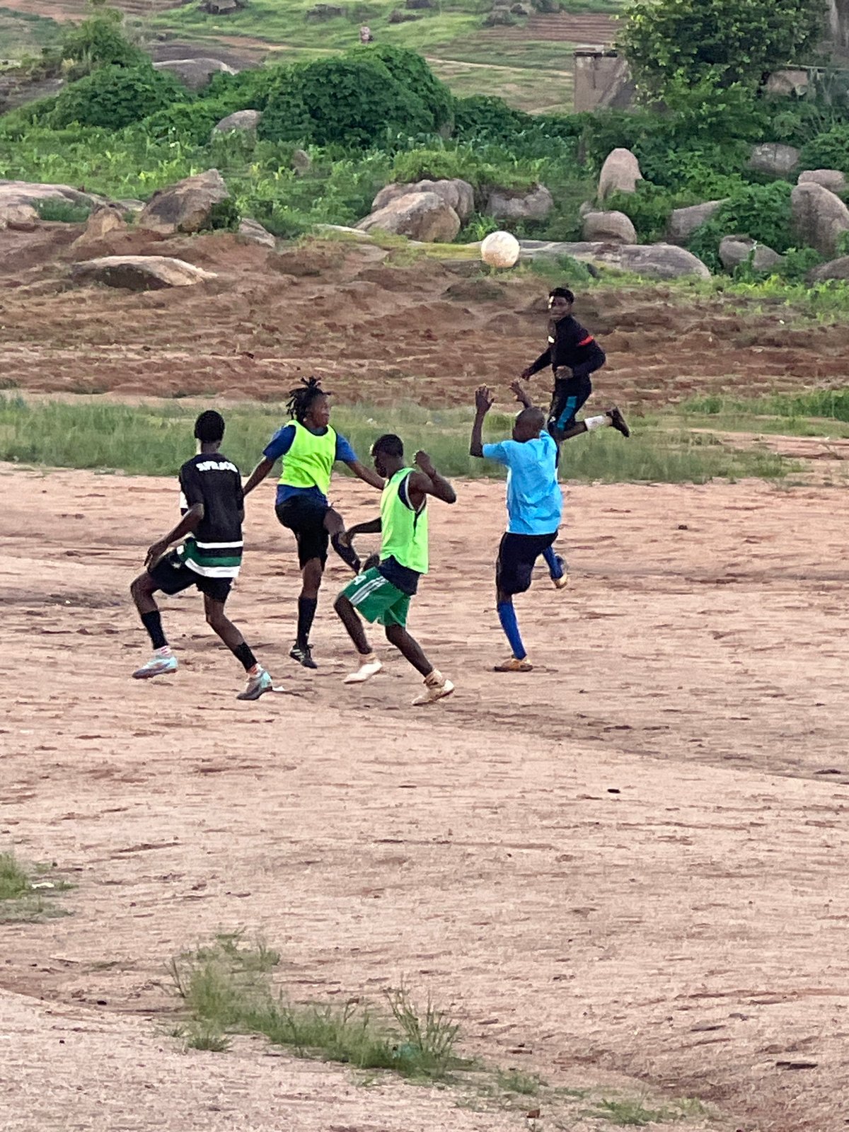 Pickup football on a rocky dirt pitch in Jos, Nigeria