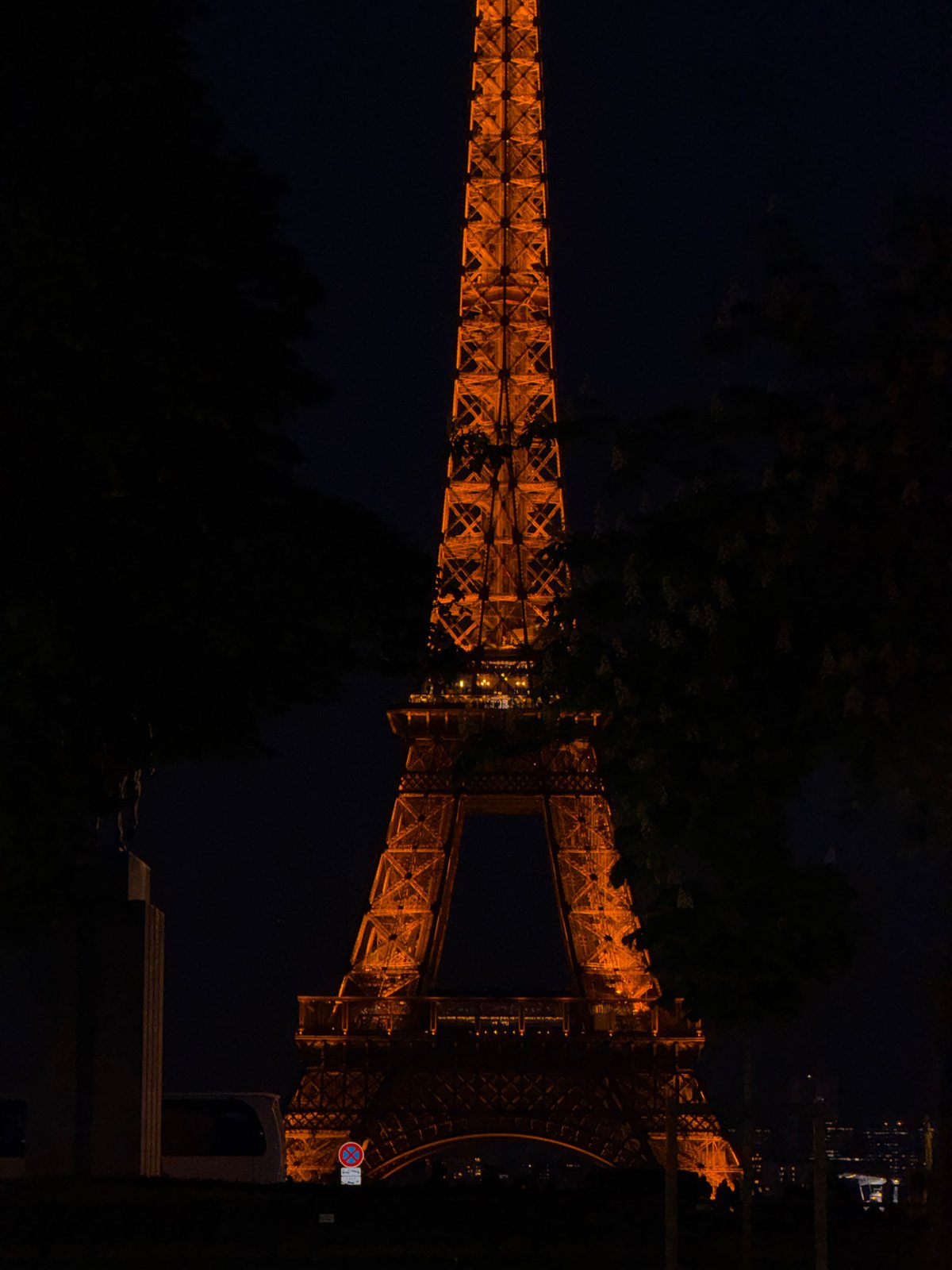 Eiffel Tower glows golden in evening illumination, Paris