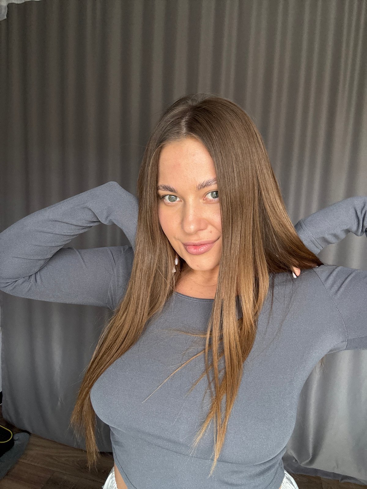 Woman takes morning selfies with cat in Chernushka apartment