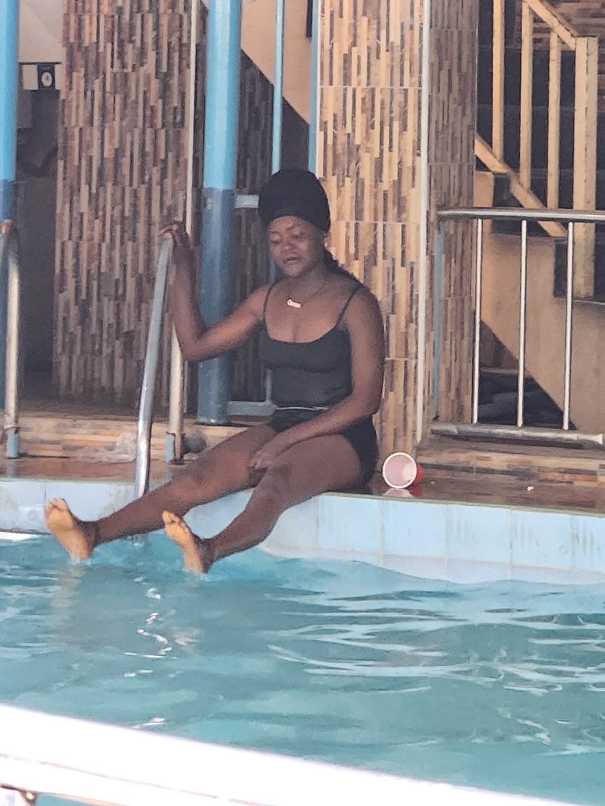 Pool gathering with swimmers and visitors in mixed attire