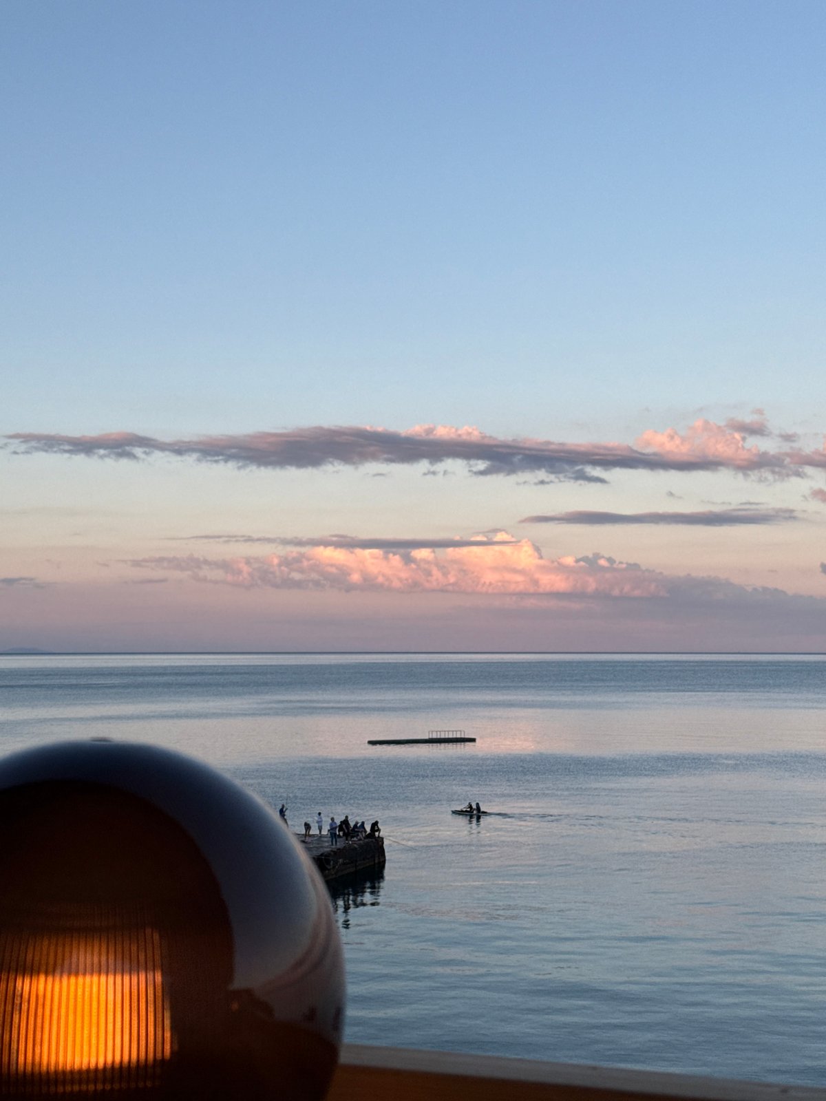 Sunset evening at a waterfront terrace in Partenit