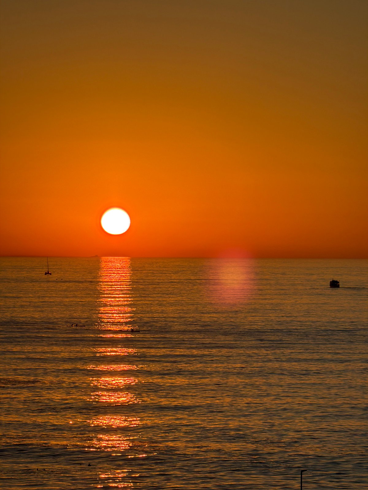 Cape Town sunset viewed over ocean with wooden posts