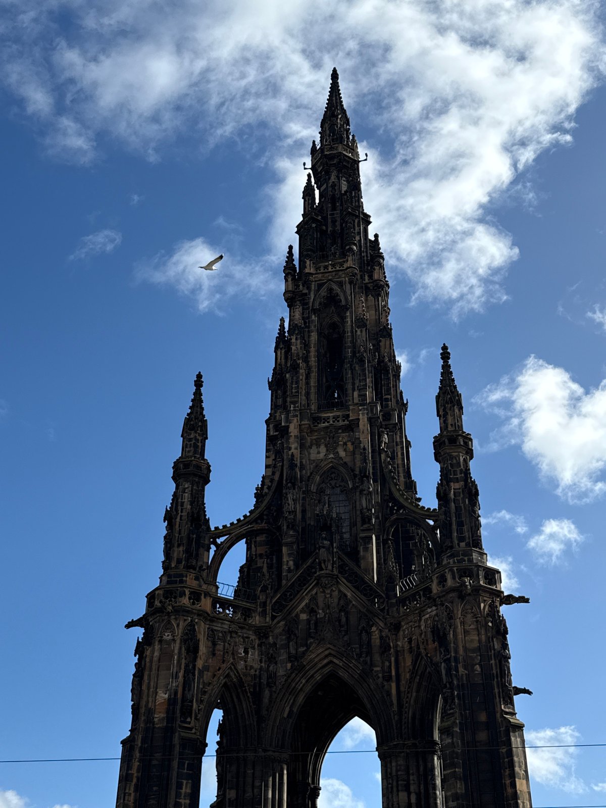 Tourist documents Edinburgh's Scott Monument from multiple angles