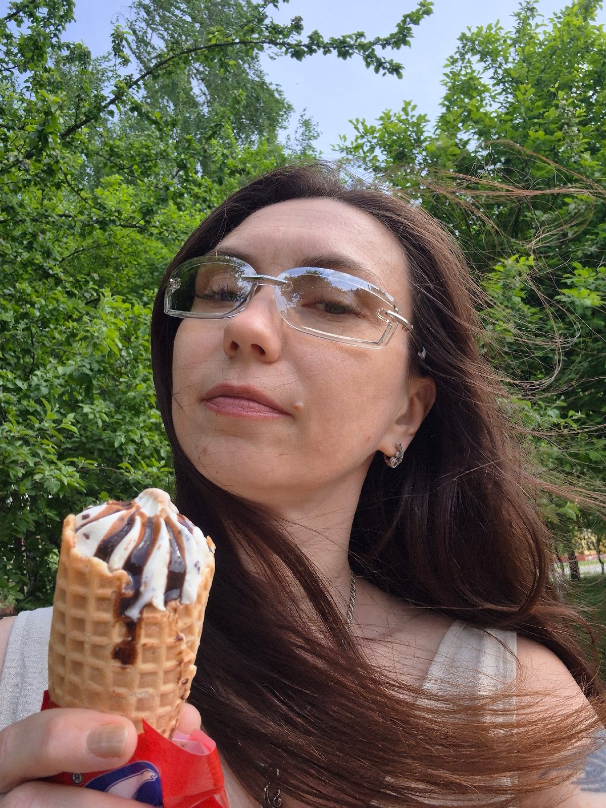 Park visitor captures ice cream, bench relaxation, fruit hashtag moments