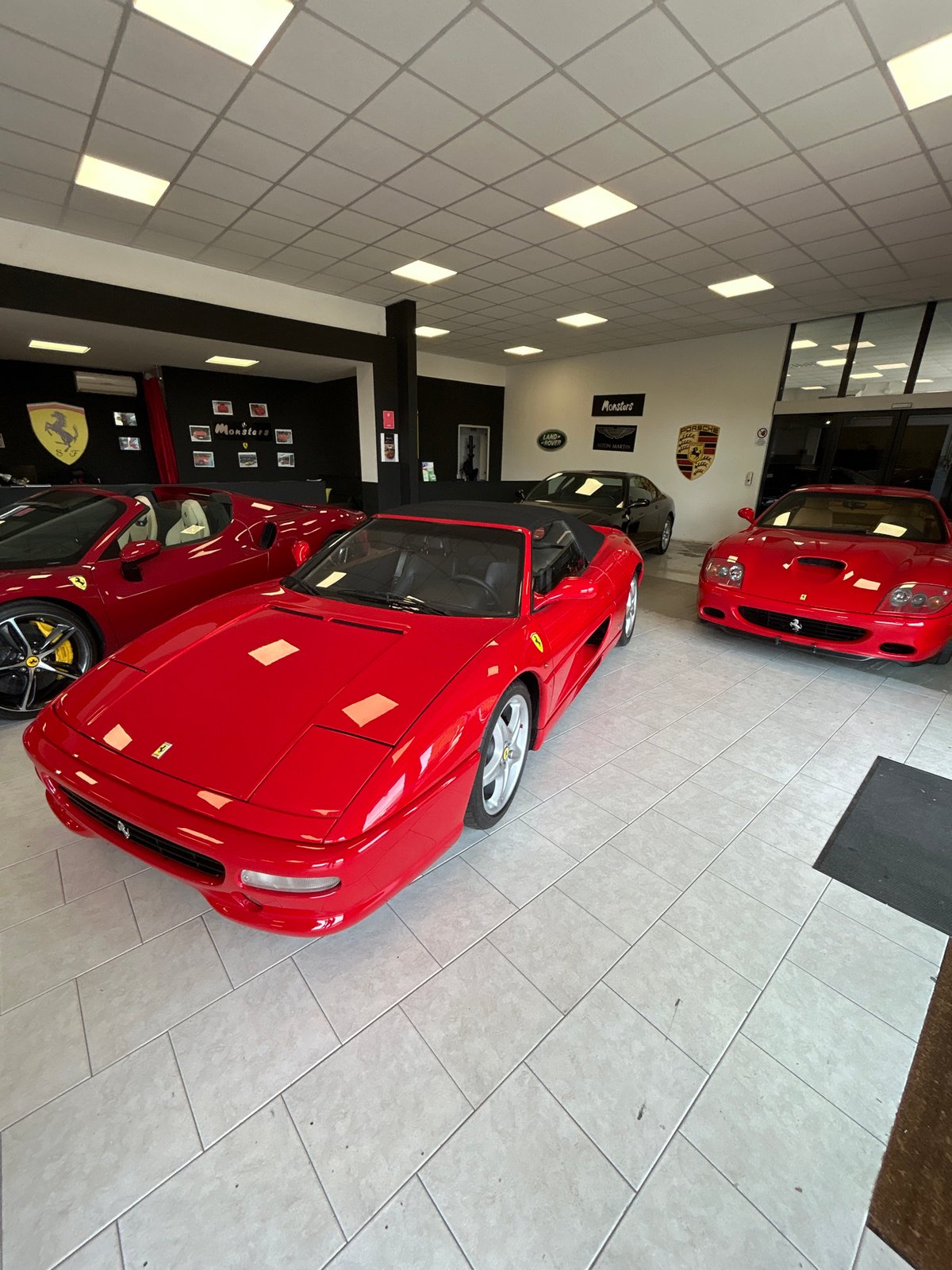 Luxury car dealership showcases Ferrari, Mercedes, Porsche in Sirmione