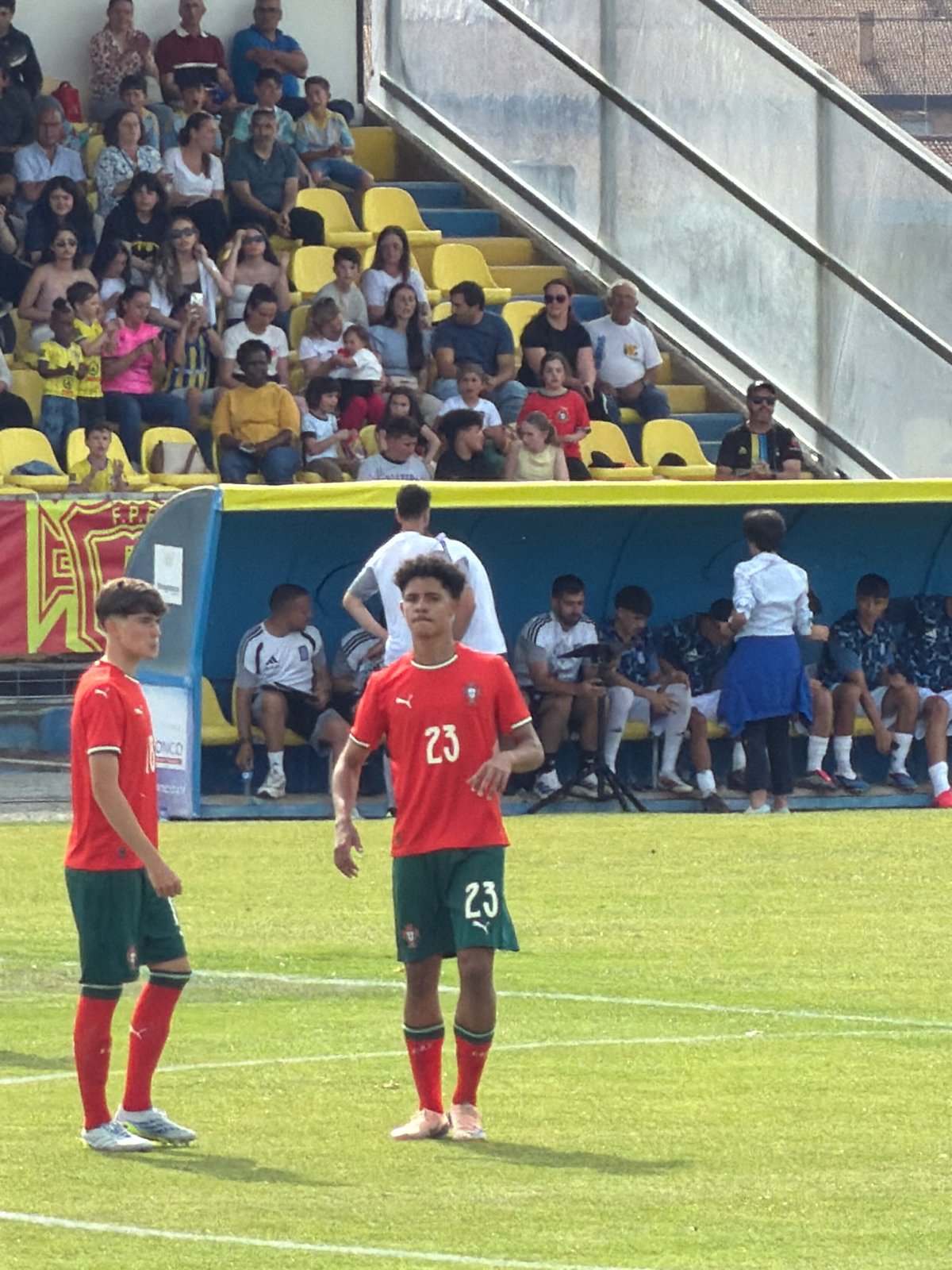 Soccer match underway in Bragança, Portugal on sunny afternoon
