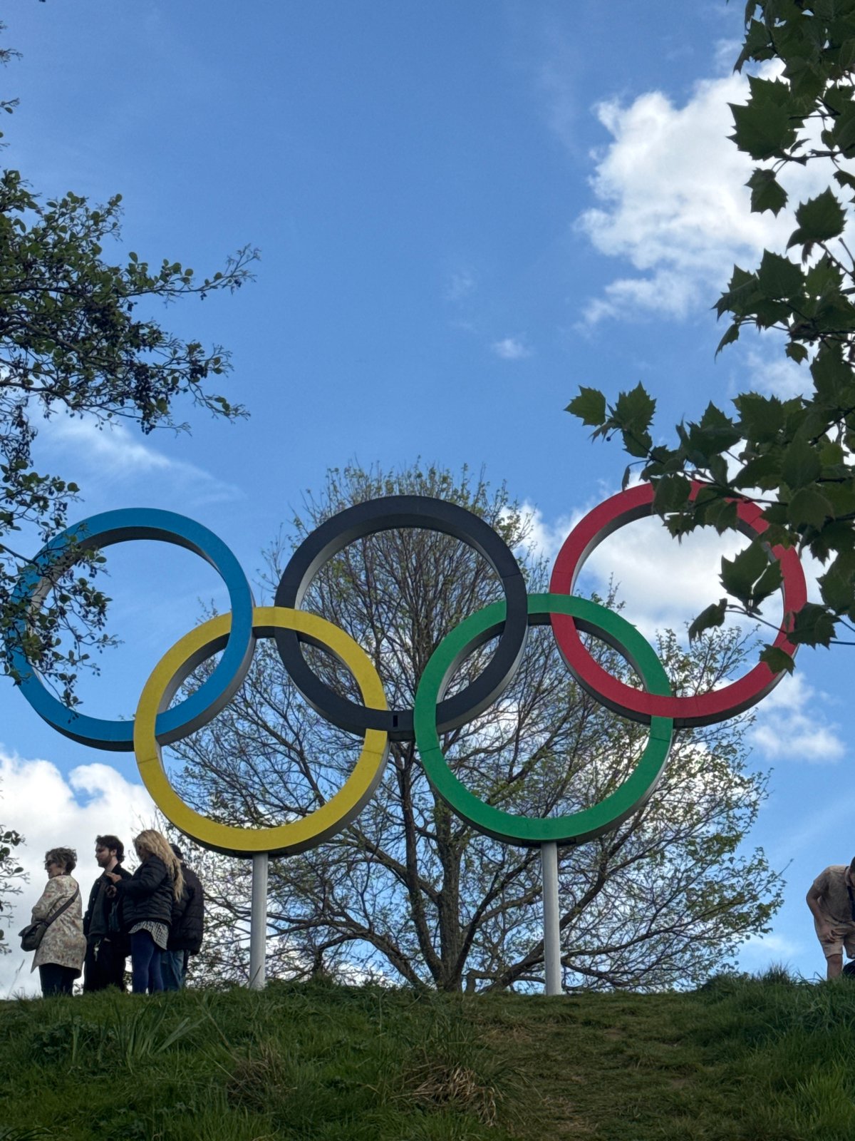 Visitor documents Olympic Park landmarks under afternoon London skies