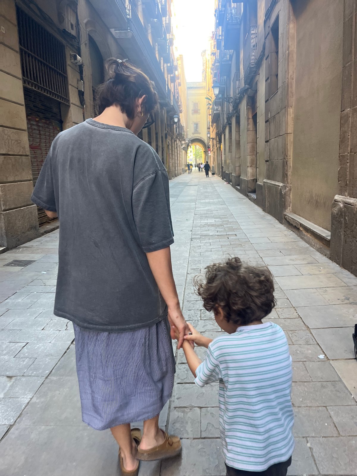 Adult and child walk through Gothic Quarter during renovation