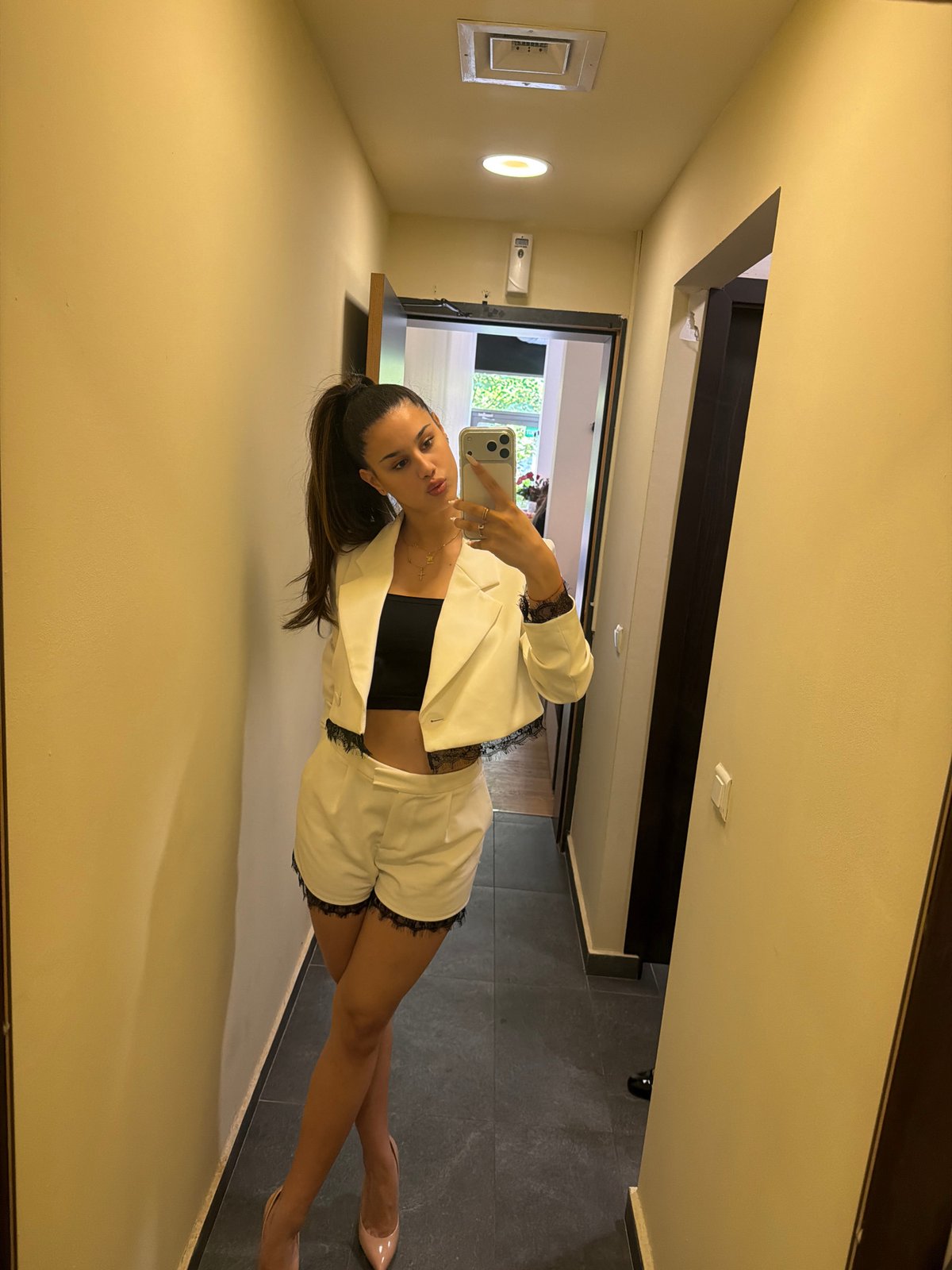 Woman in white blazer photographed at two Sofia locations