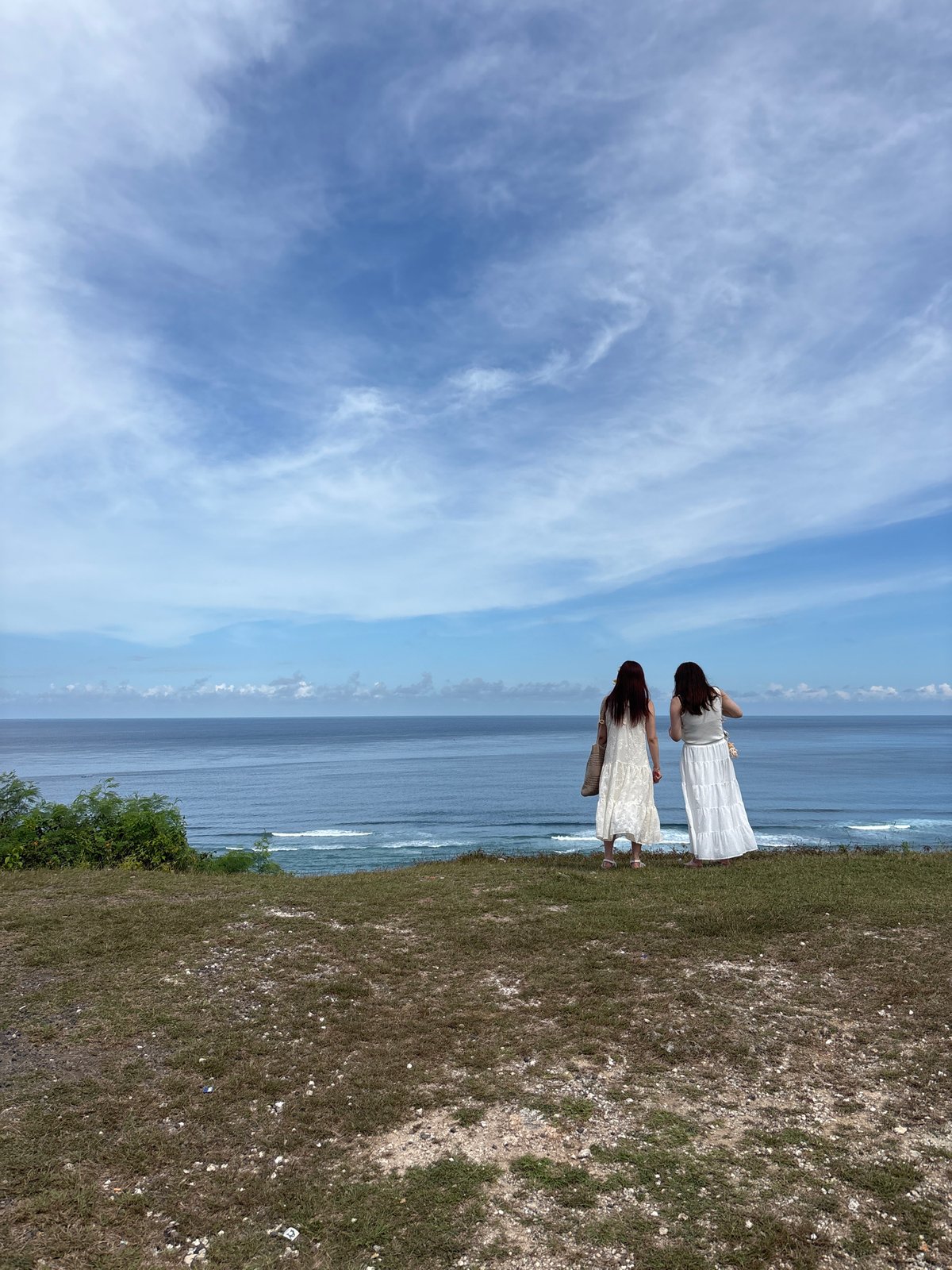 Two women photograph coastal visit in Kuta Selatan
