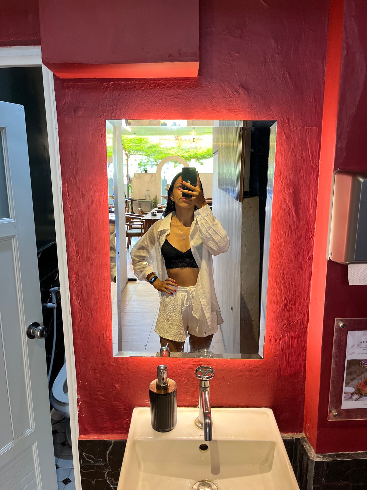 Women take bathroom mirror selfies in Kuta Selatan