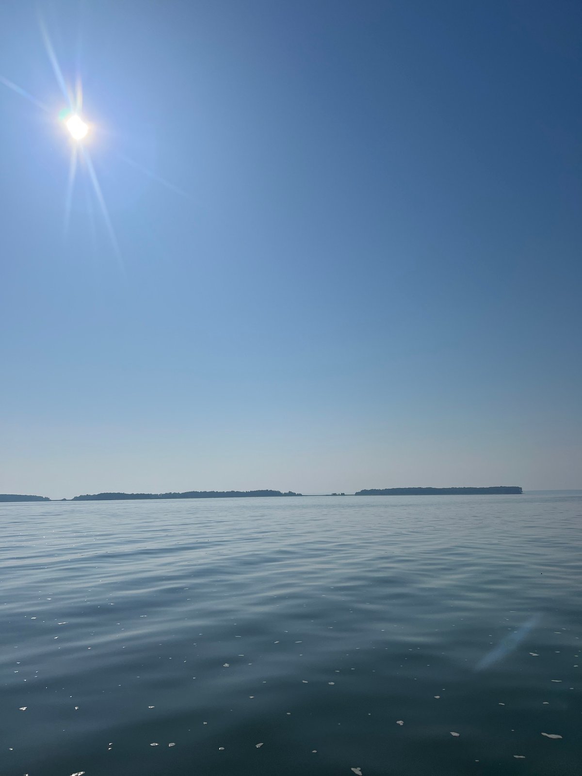 Fishing a calm Siberian lake on a bright summer morning
