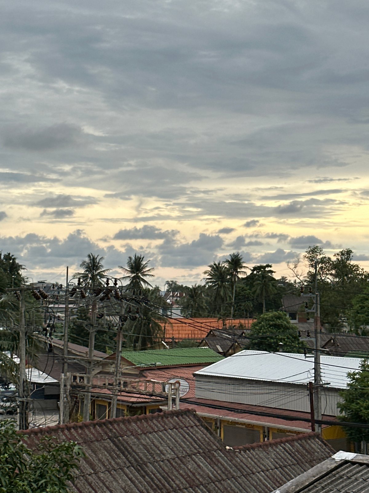 Overcast morning in Karon — rooftops, street life, and slow downtime