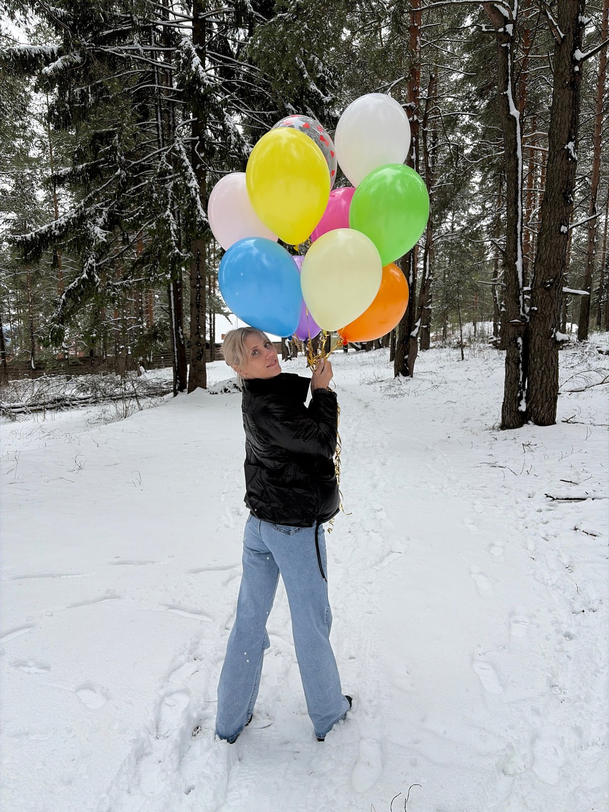 Woman with balloons spotted in snowy Russian woodland