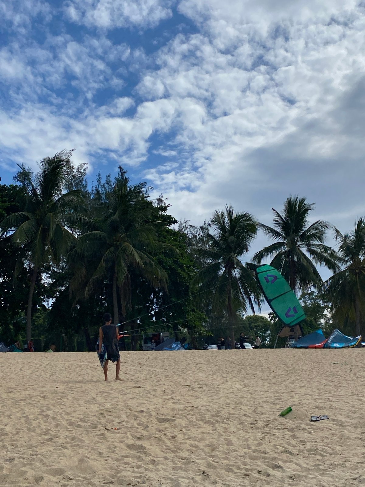 Kitesurfing gear and action spread across Nha Trang beach