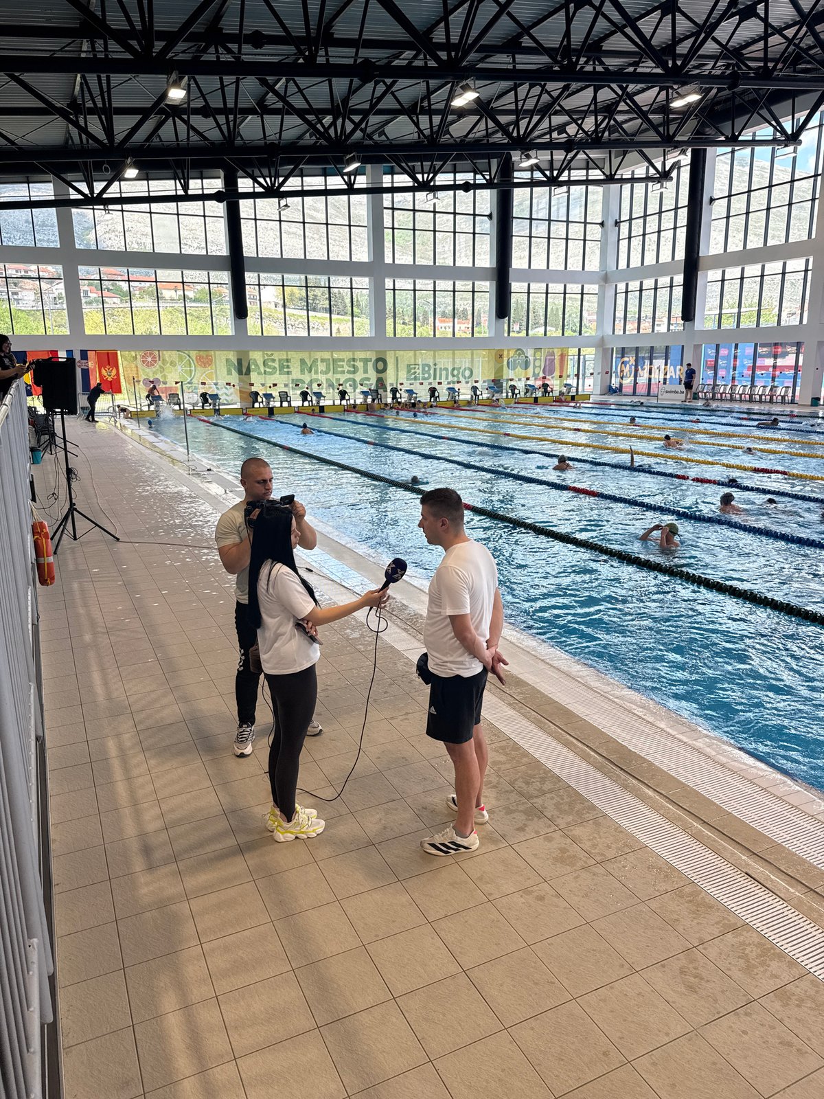 Reporter interviews subject at Trebinje Olympic Pool facility
