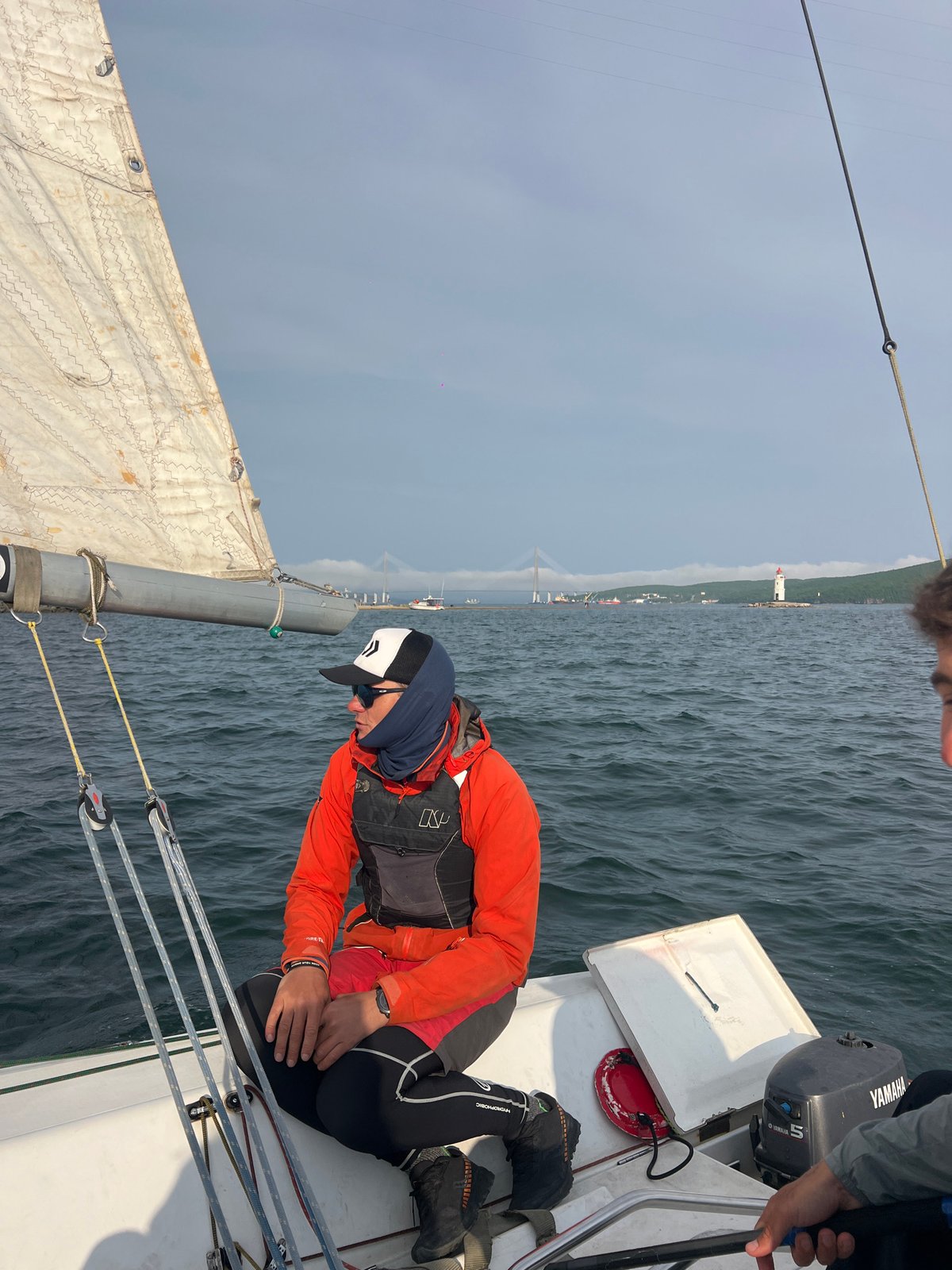 Sailing crew enjoys choppy waters near Vladivostok under overcast skies