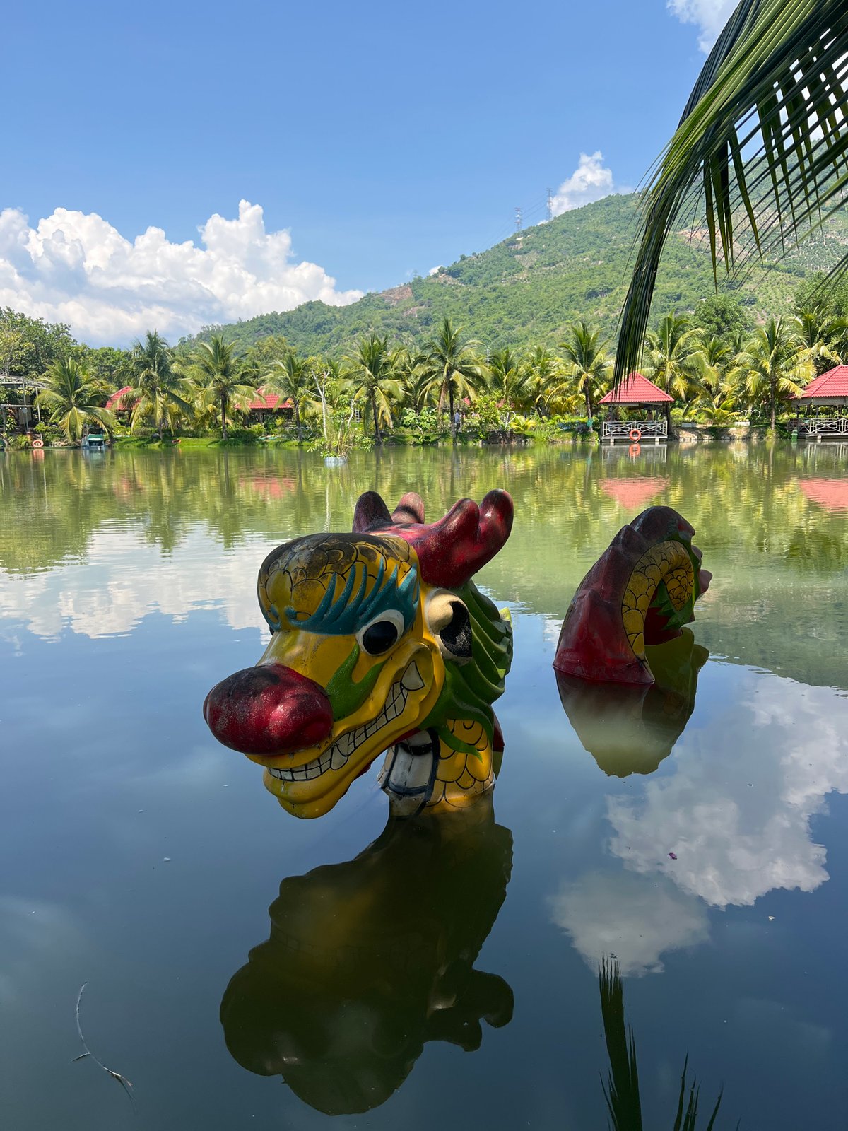 Lakeside nature and folk art details at a Vietnamese park