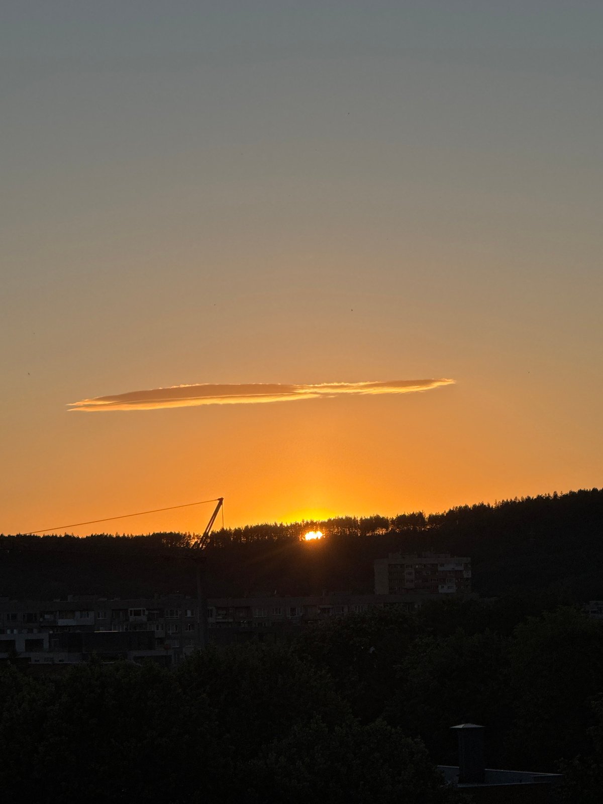 Sunset over Pernik's hills, clouds and warm light on full display