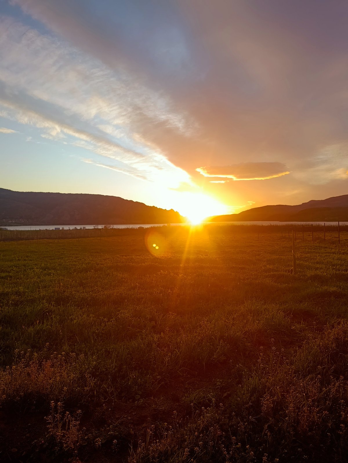 Sunset observed over Bulgarian field with water reflection
