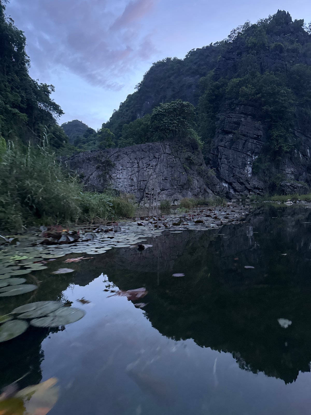 Twilight boat tour through Vietnam's limestone caves and waterways