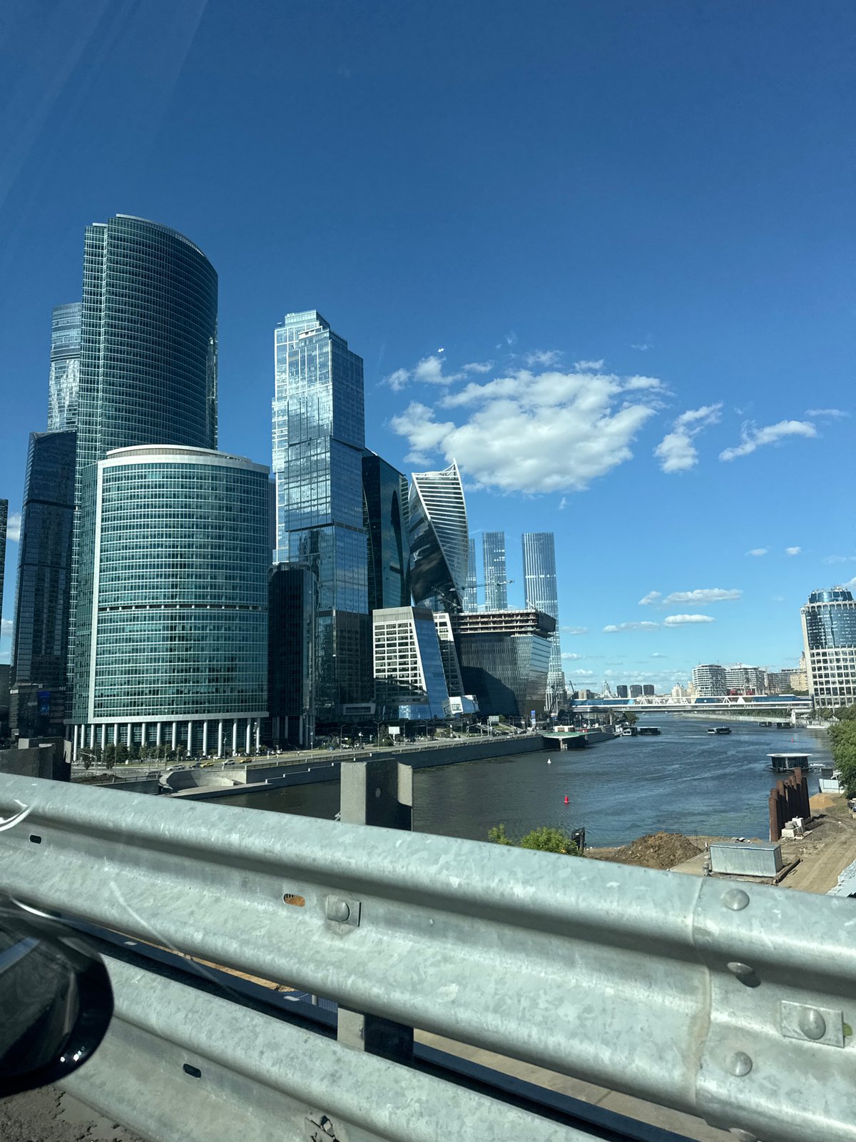 Driving past Moscow City's glass towers on a clear afternoon