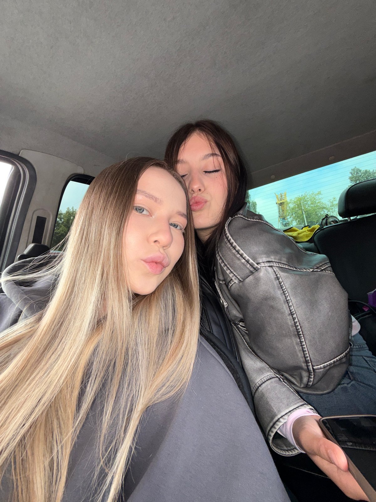 Young women take playful selfies, eat strawberries in Chaikovsky