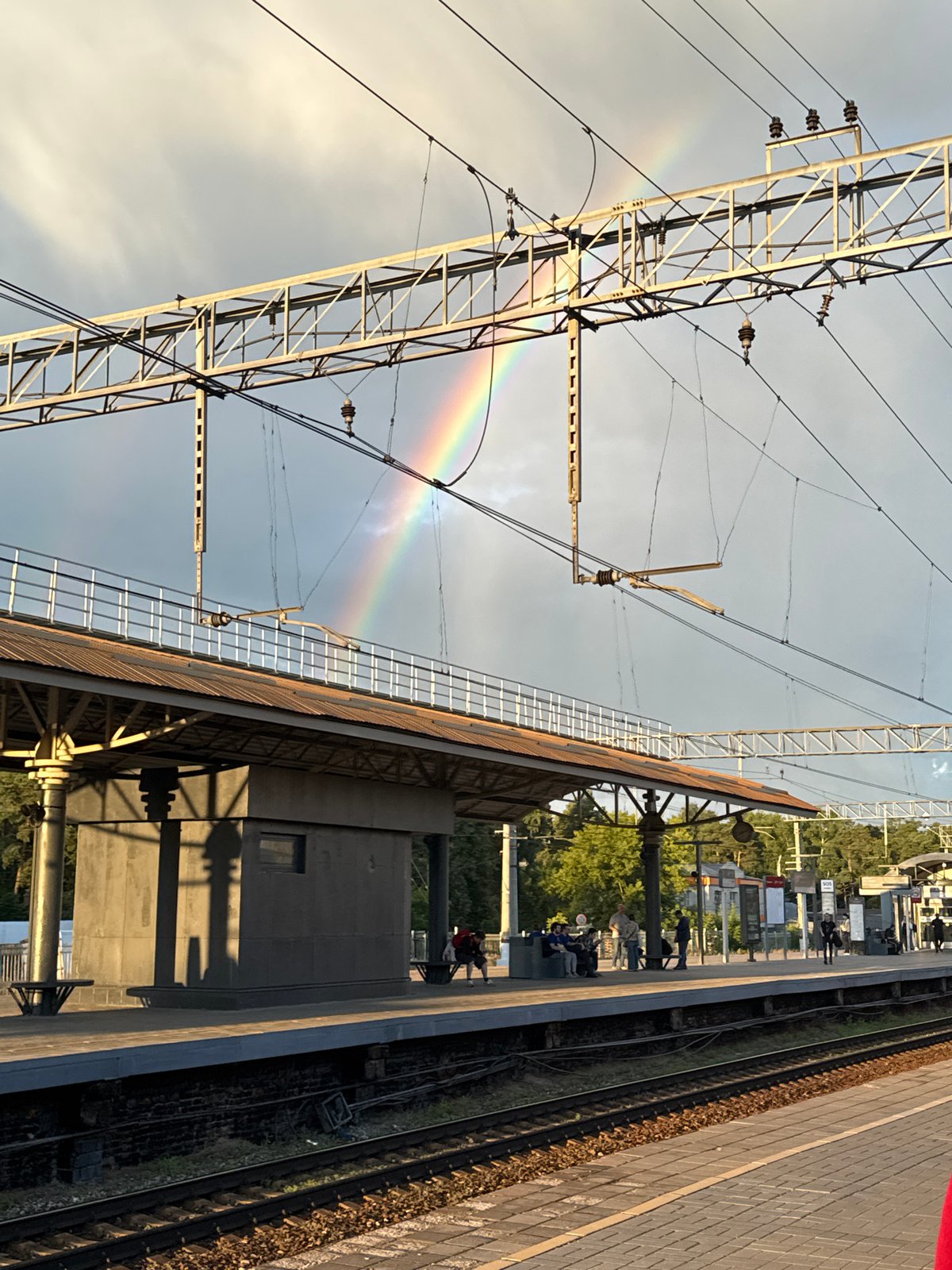 Rainbow over Bykovo station, dog chilling on the platform