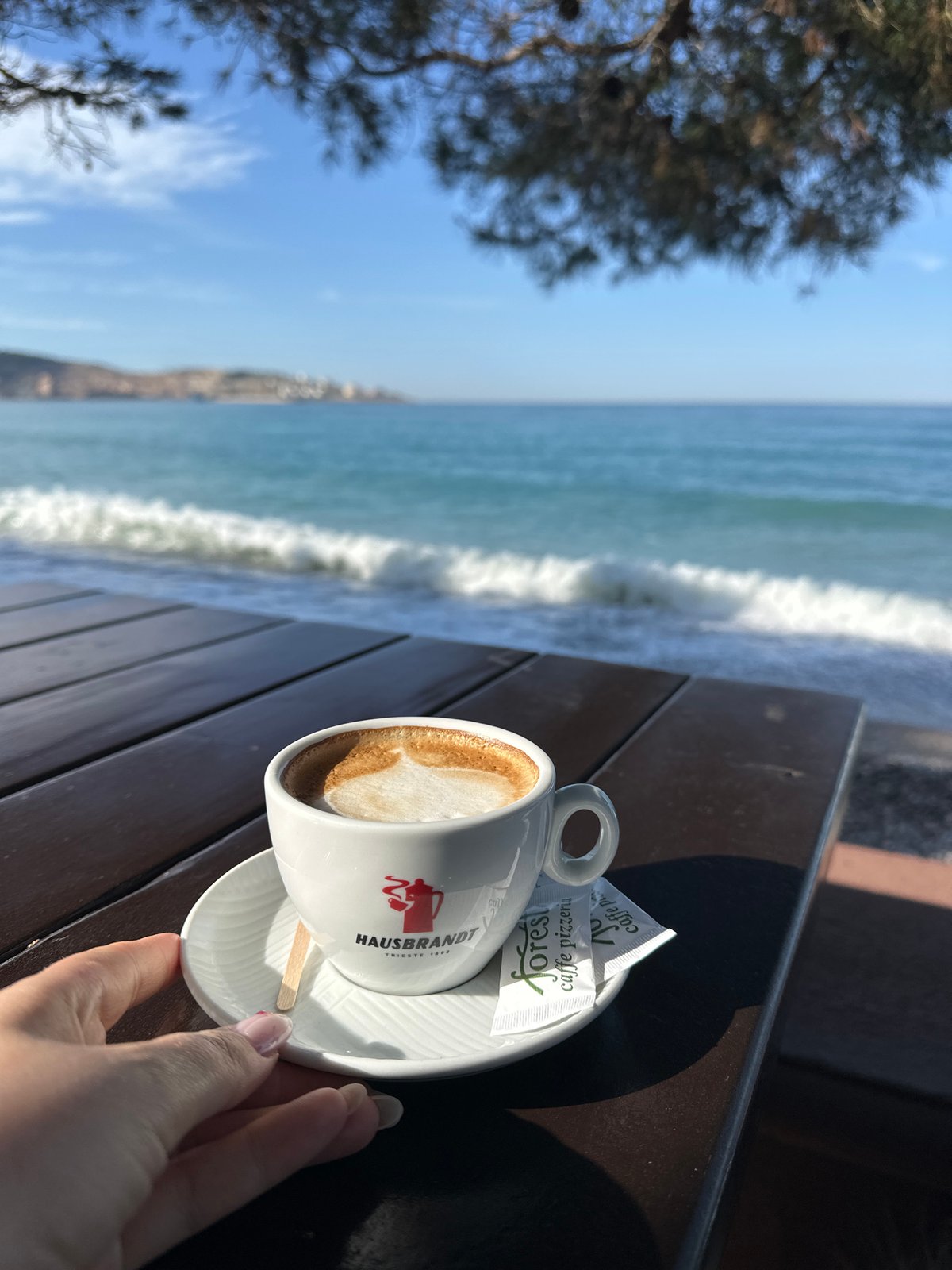 Woman enjoys morning cappuccino in Šušanj, Montenegro