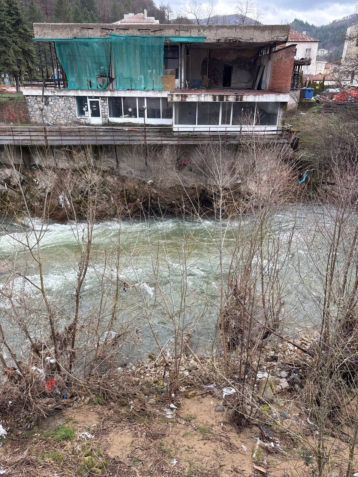 Fast-flowing river with debris observed in Rudozem, Bulgaria