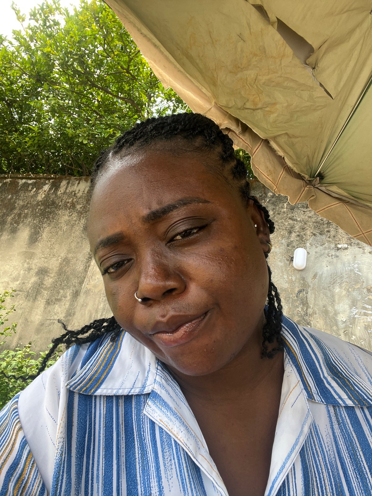 Everyday street life along a busy Abuja roadside
