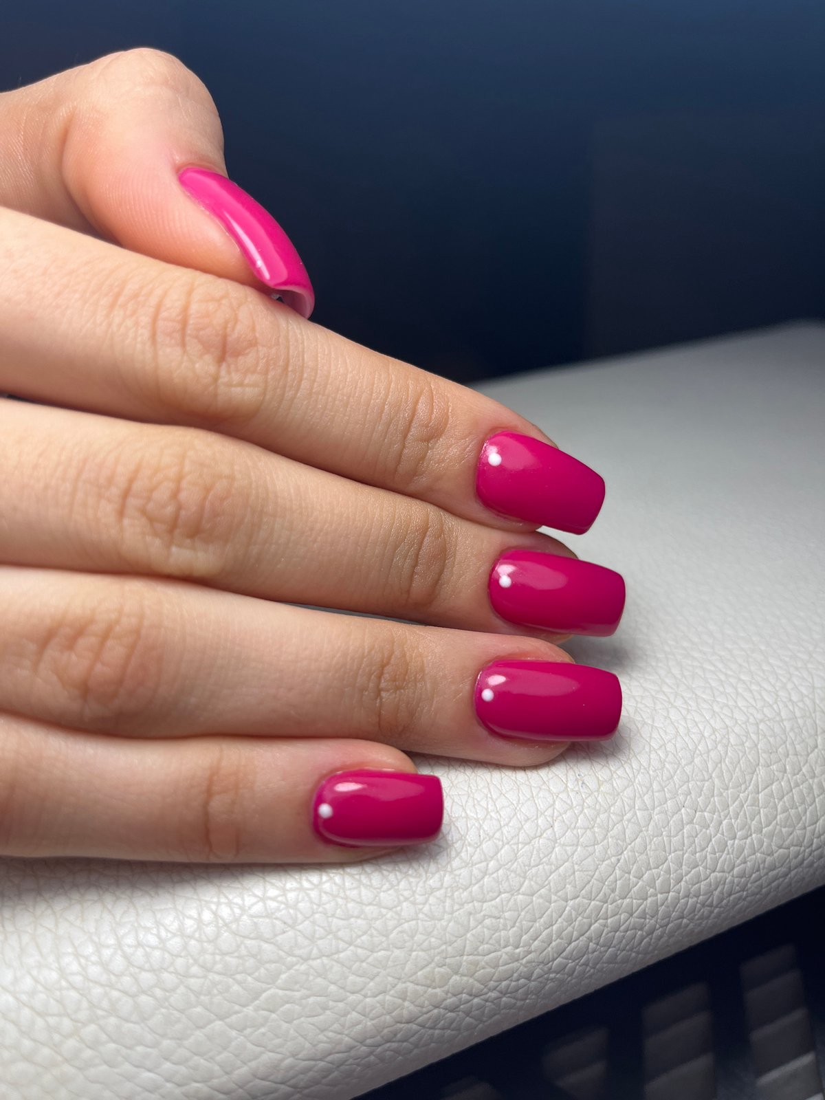 Magenta manicure with white dots photographed in Pernik