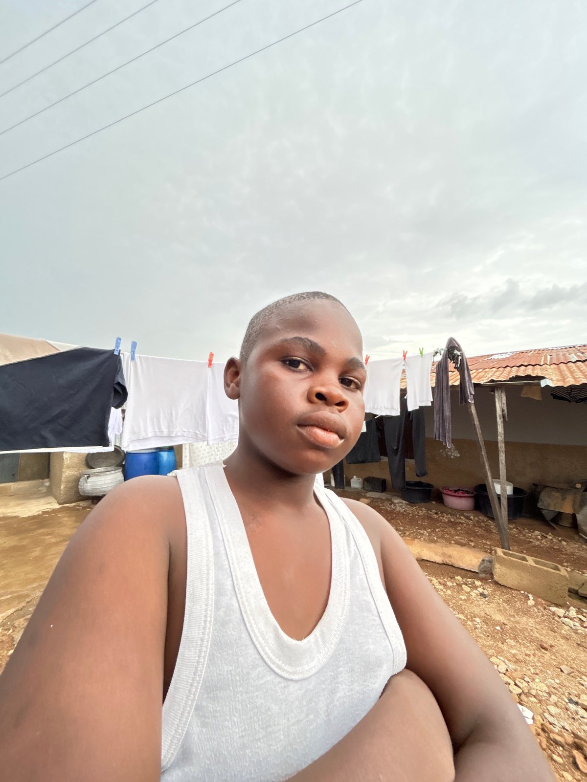 Everyday street life across Jos, Nigeria on a cloudy afternoon