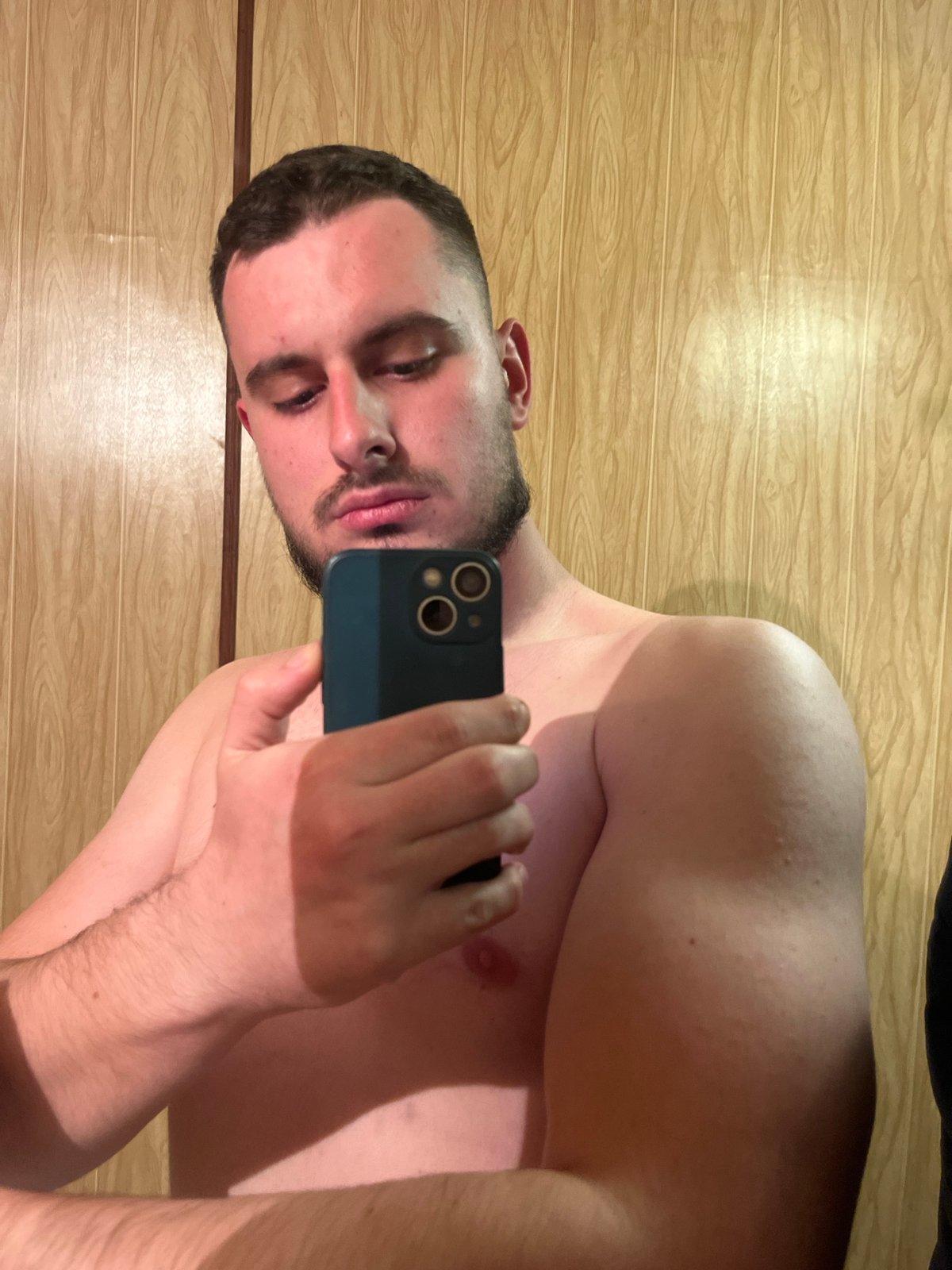Man takes selfie against wooden wall in Burgas