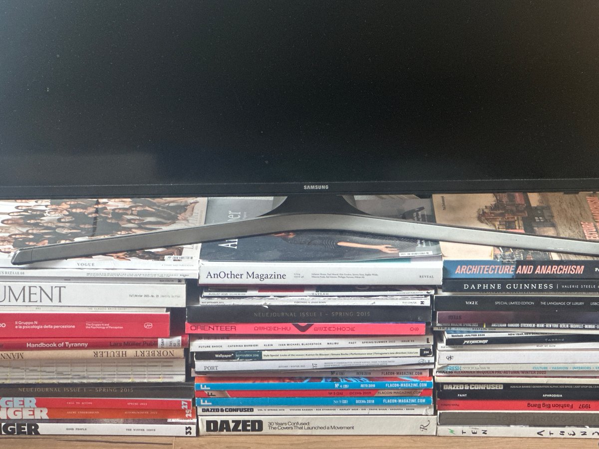 London resident uses fashion magazines as makeshift monitor stand