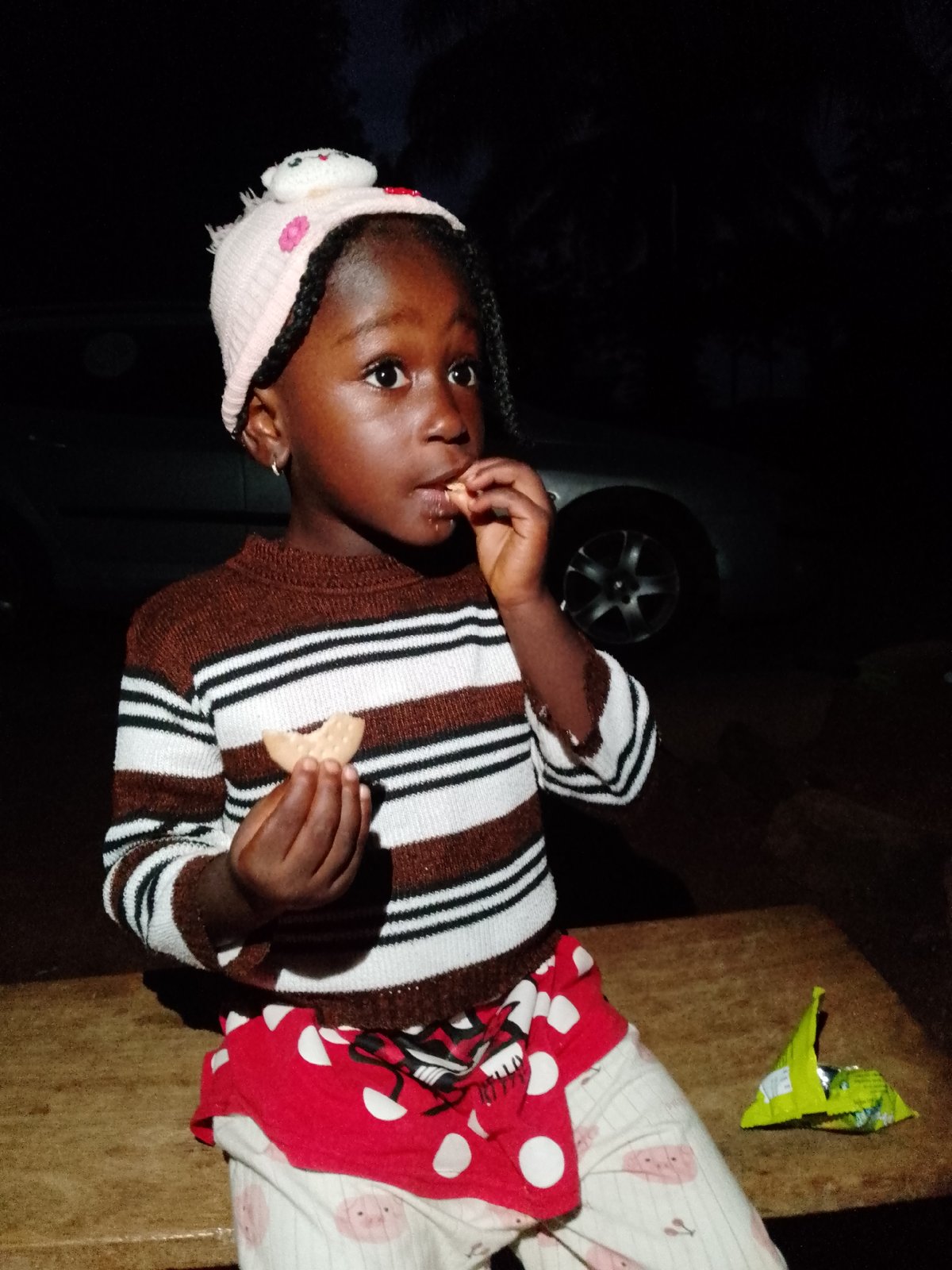 Snack time on a wooden surface, pink beanie and polka dots
