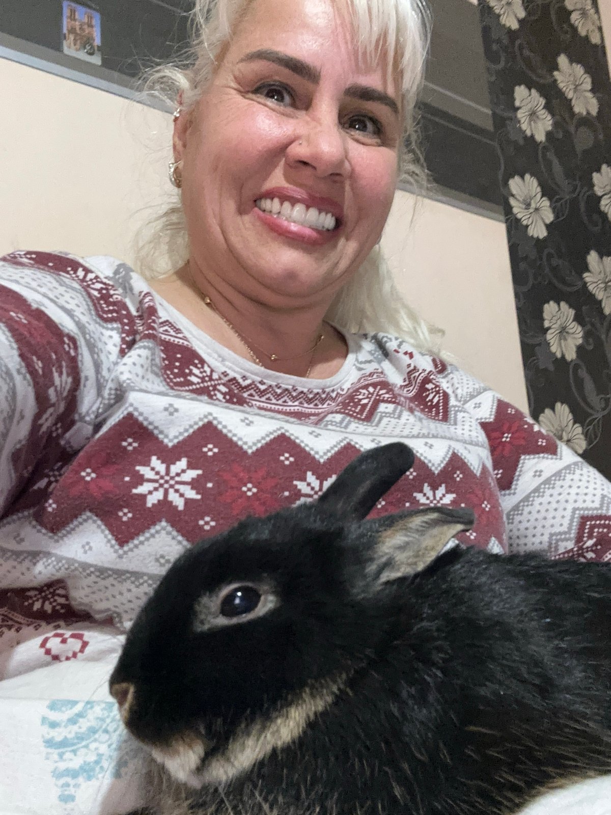 Woman poses with dark rabbit for selfie in Sofia