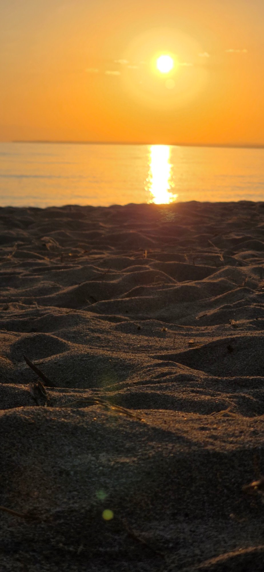 Golden sunset over sand and water in rural Kyrgyzstan