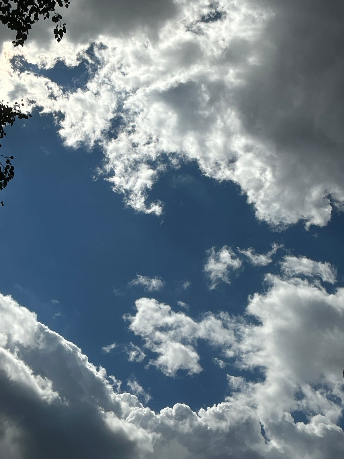 Looking up: dramatic skies and a curved skyscraper